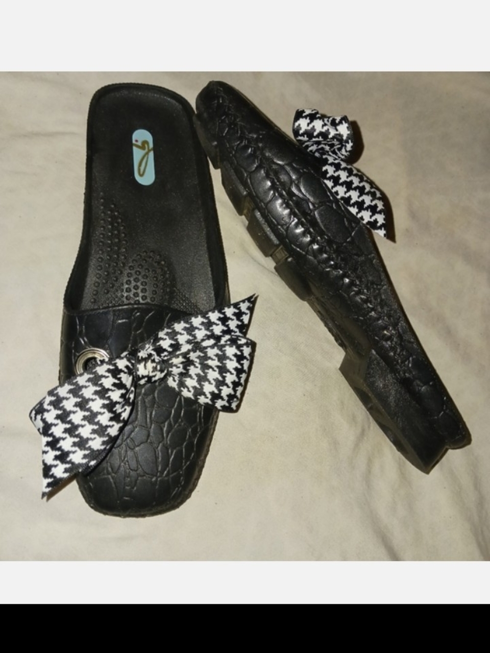 Oka-B Madison slide sandals in black with a houndstooth or patterned bow accent.